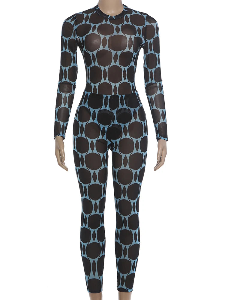 A long-sleeve, full-length bodysuit or wetsuit with a black base and a repeating light blue abstract oval pattern, displayed on a mannequin against a plain white background.