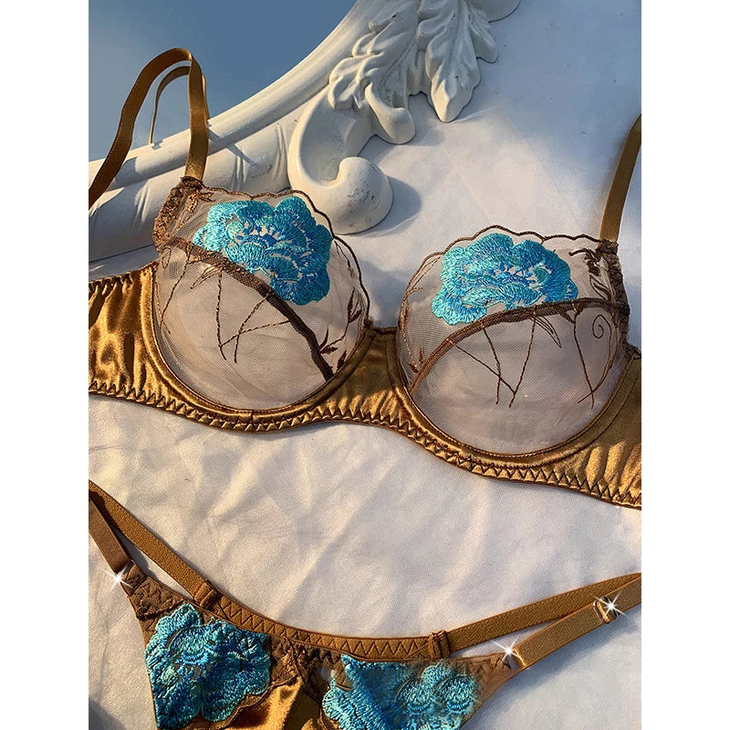 Gold and blue bra set on a decorative stone surface