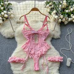 Pink lace lingerie set on a white fur rug with floral decorations.