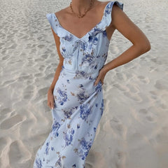 Woman wearing a floral dress on a sandy beach