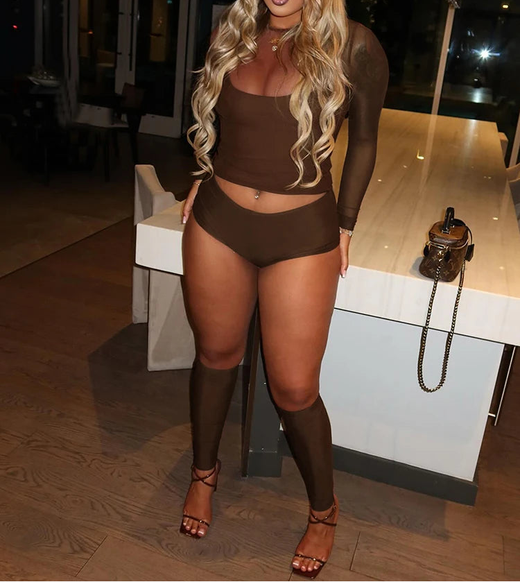 Woman in a brown outfit standing in an indoor setting