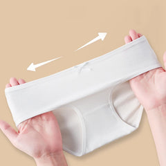 White underwear held by hands on a beige background