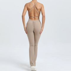 Person wearing a beige sports bra and leggings set on a white background