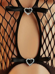 Black fishnet stockings with heart-shaped garters on a mannequin.