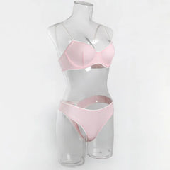 Pink bra and panties set on a mannequin against a white background