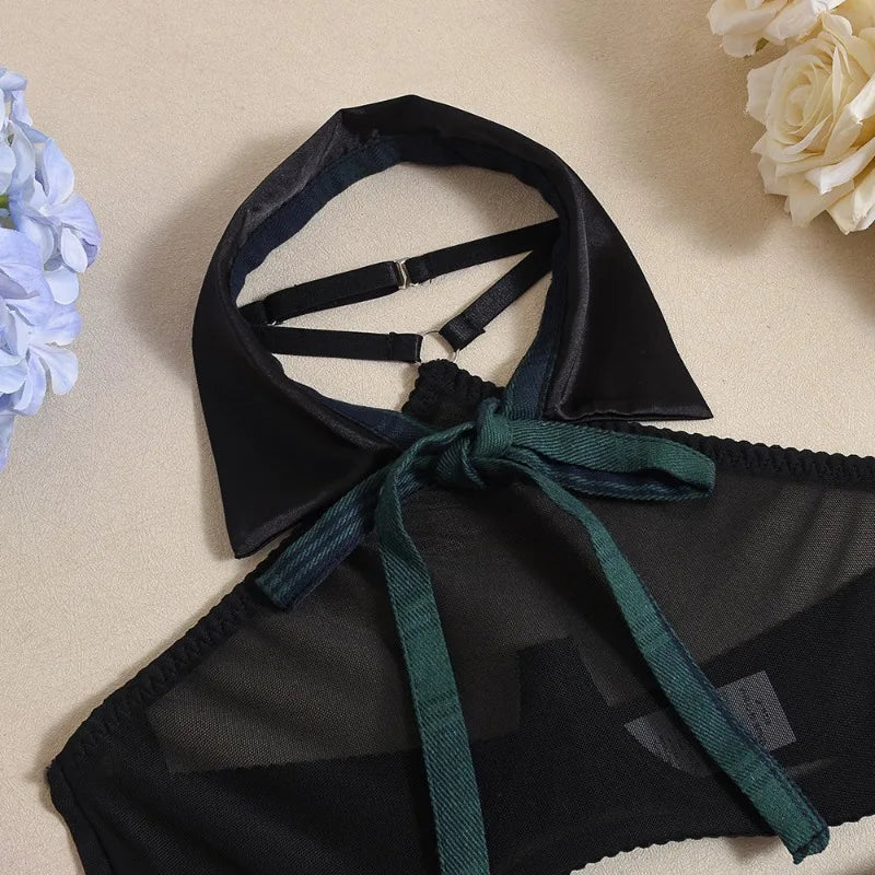 Black and green lingerie set on a beige background with flowers.