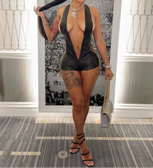 Woman in a revealing outfit holding a baseball bat in an indoor setting