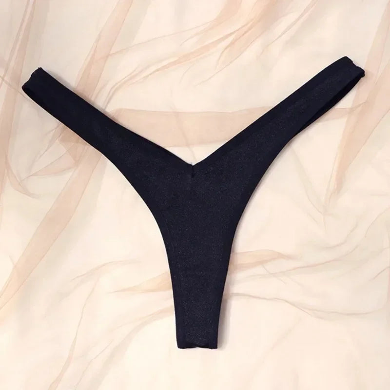 Black thong on a beige fabric background