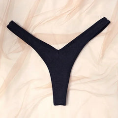 Black thong on a beige fabric background