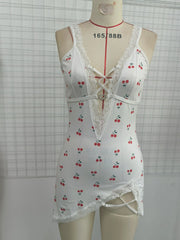 White lace-trimmed nightgown with cherry pattern on a mannequin against a grid background