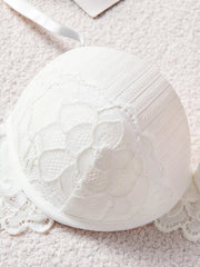 White lace bra on a textured surface