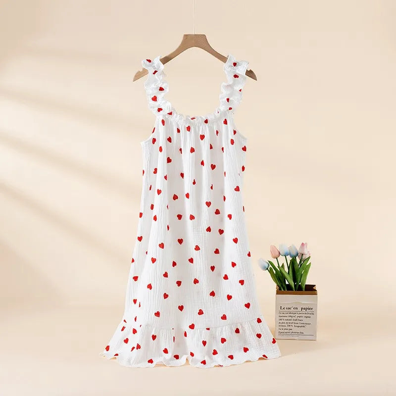 White dress with red heart patterns on a beige background