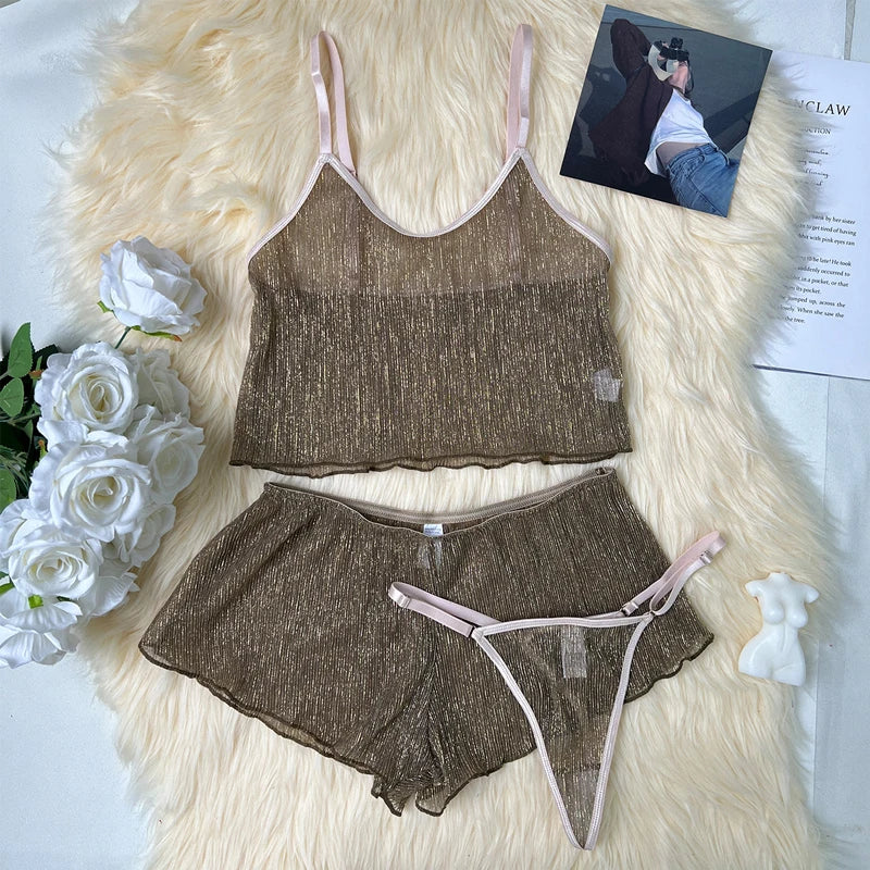 Brown lingerie set with pink straps on a fluffy white surface with flowers and a magazine.