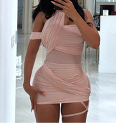 Woman taking a mirror selfie wearing a pink one-shoulder dress.