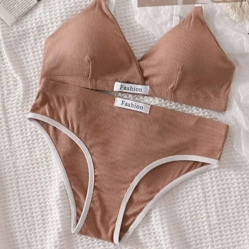 Brown ribbed bikini set with 'Fashion' labels on a textured white surface