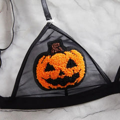 Halloween-themed bra with a jack-o'-lantern patch on a white background