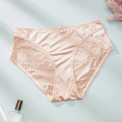 Pink lace underwear on a light gray background