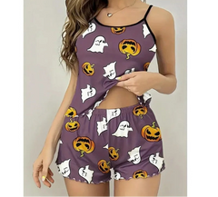 Woman wearing a Halloween-themed pajama set with pumpkins, ghosts, and ghosts on a purple background.