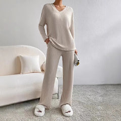 Person wearing a beige ribbed loungewear set in a minimalistic room.