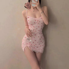 Person wearing a pink lace nightgown holding a glass against a plain background