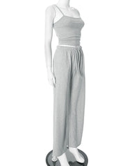 Mannequin wearing a gray one-shoulder top and wide-leg pants on a white background