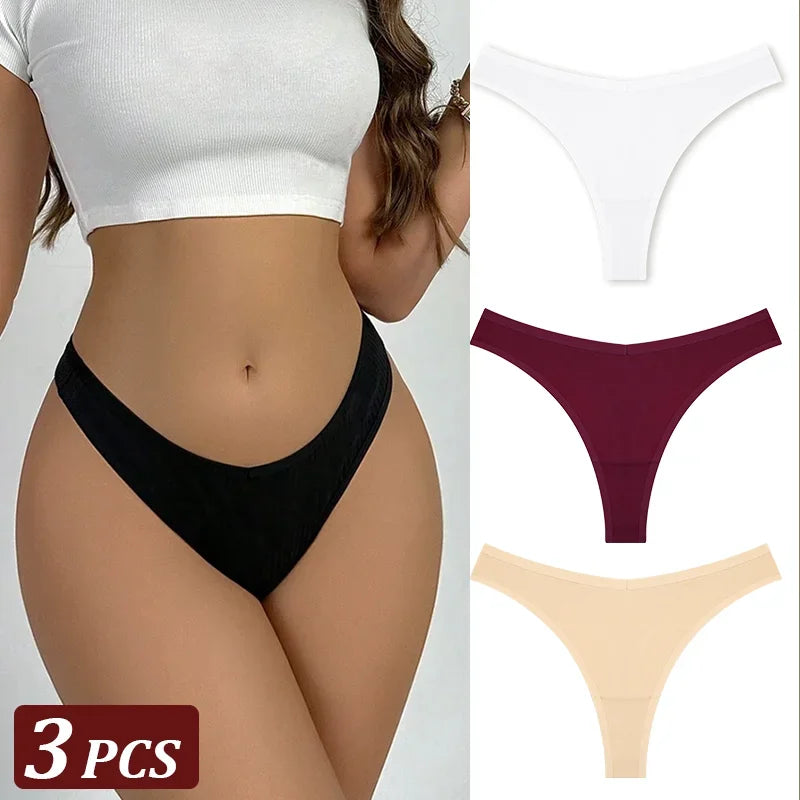 Black thong worn by a person with additional thongs in maroon and beige displayed on a gray background.