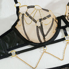 Black and gold bra with chain details on a white background