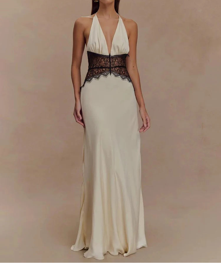 Woman wearing a long, elegant dress with a black lace bodice on a beige background