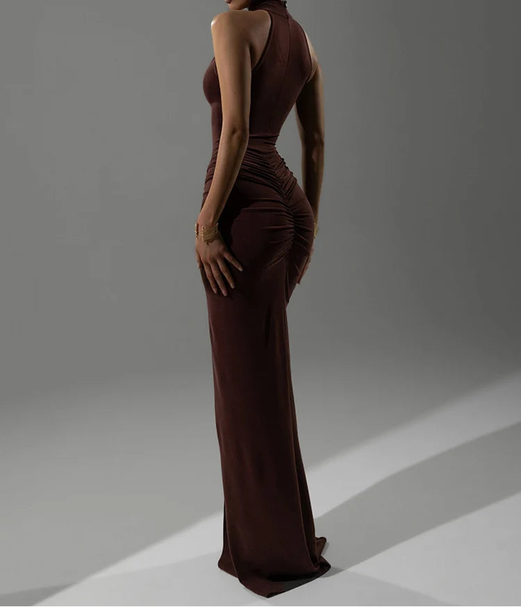 Woman wearing a brown evening gown against a gray background