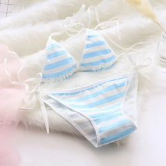 Blue and white striped bikini set on a soft, blurred background