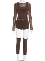 Brown outfit with sheer sleeves and white pants on a mannequin against a white background