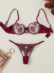 Burgundy lace lingerie set with flowers on a light background