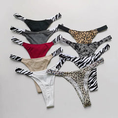 Flat lay of women's G-string thongs in solid shades and animal-print designs.
