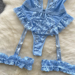 Blue lace lingerie set on a beige surface