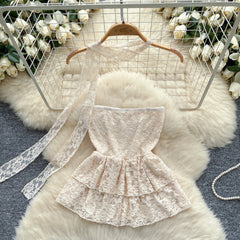 Lace dress on a hanger with floral decorations in the background