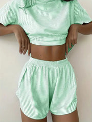 Person wearing a green and white striped outfit on a plain background