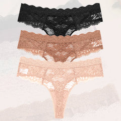 Three pairs of lace underwear in black, rose gold, and pink on a textured gray background.