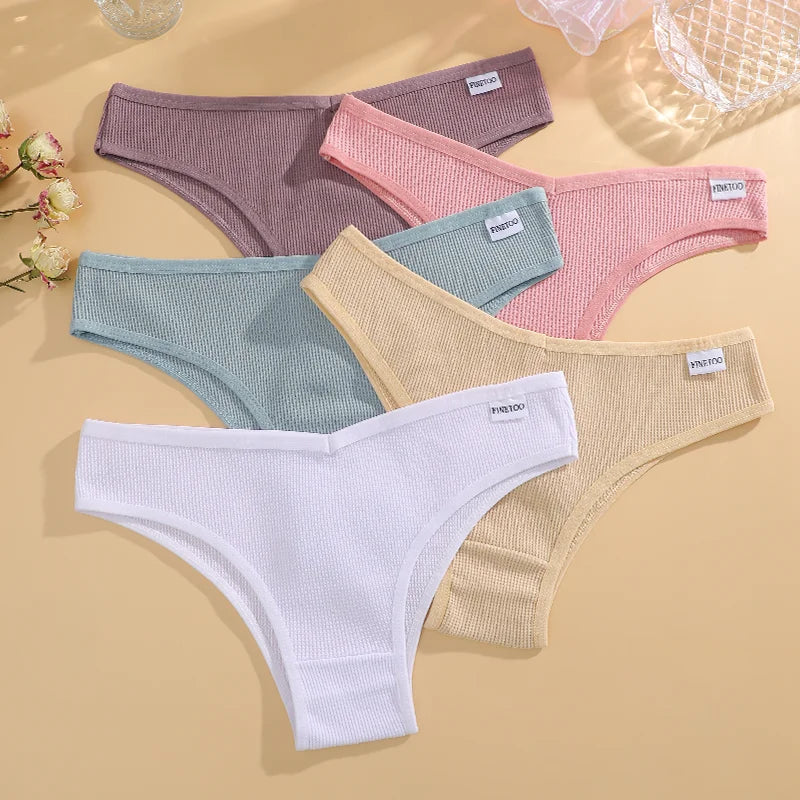 Set of women's underwear in various colors on a beige background