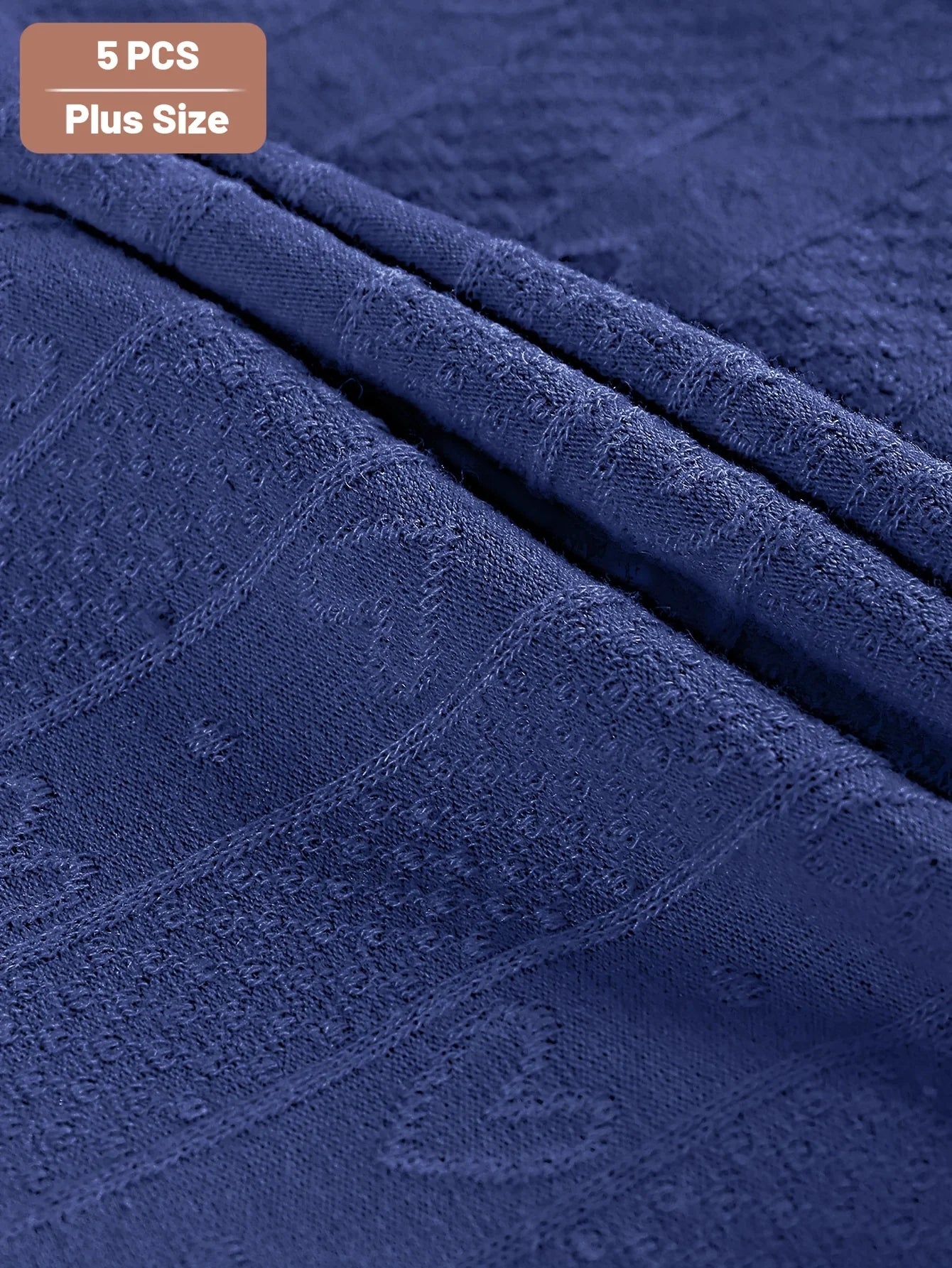 Close-up of blue textured fabric with '5 PCS Plus Size' text at the top.