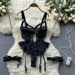 Black lace lingerie set on a white fur rug with floral decorations.