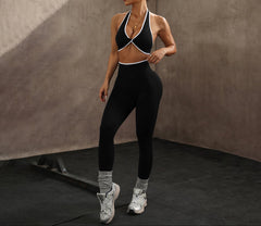 Woman in black athletic wear standing in a gym setting