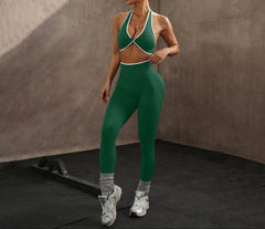 Woman in green athletic outfit posing against a neutral background