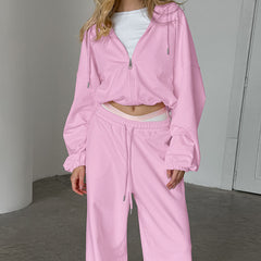 Person wearing a pink tracksuit in an indoor setting