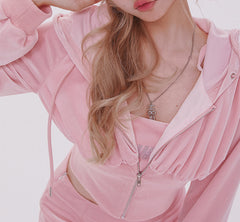 Person wearing a pink outfit with ruffled sleeves on a white background