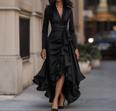 Woman in a black dress walking on a city street