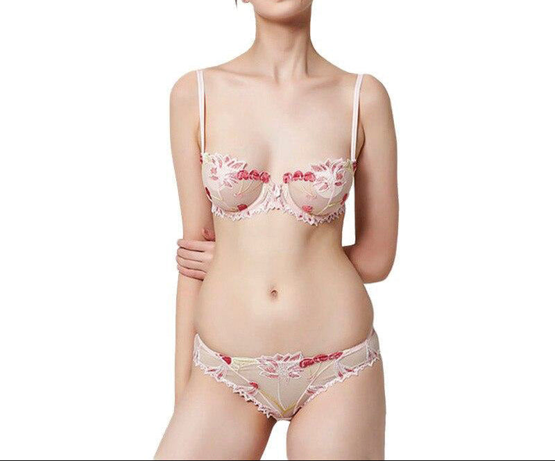 A woman wearing a floral embroidery lace see-through bra underwear set with adjustable straps.