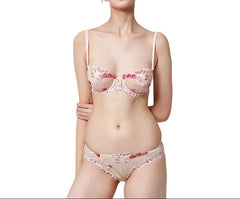 A woman wearing a floral embroidery lace see-through bra underwear set with adjustable straps.