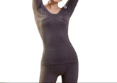 A woman modeling a pair of gray long johns with a high-rise waist, made from a stretchy fabric.