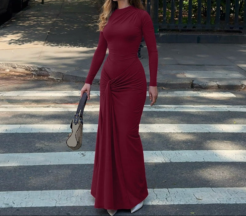 Woman in a red dress standing on a crosswalk