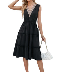 Woman wearing a black dress with lace details on a white background